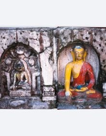 Book cover of Lost Nepal: A Photographic Memoir; featuring a figure standing in front of a hut with thatched roof, and misty mountains behind. Published by ORO Editions.
