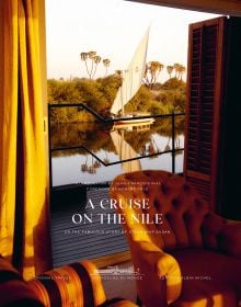 View of boat on the Nile from open wooden doors aboard the Steam Ship Sudan, on cover of 'A Cruise on the Nile, Or the Fabulous Story of Steam Ship Sudan', by Albin Michel.