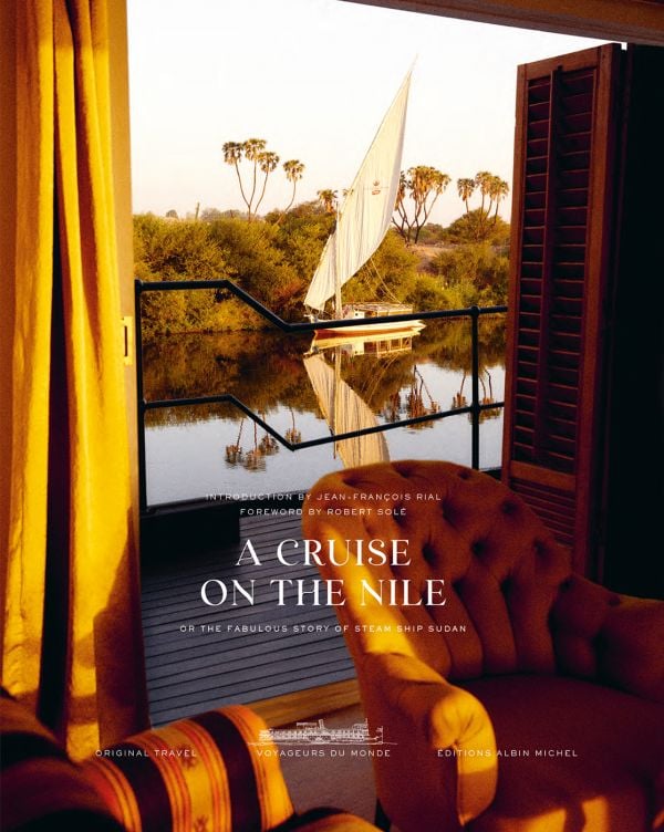 Book cover of A Cruise on the Nile, Or the Fabulous Story of Steam Ship Sudan, with a view of boat on the Nile from open wooden doors aboard the Steam Ship Sudan. Published by Albin Michel.