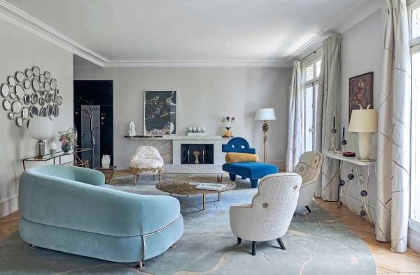 Book cover of Antidesign, with an interior living space with red walls and dark wood sculptures. Published by Editions Norma.