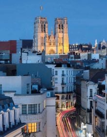 Book cover of This is Brussels; featuring the illuminated Belgian capital at night. Published by Lannoo Publishers.