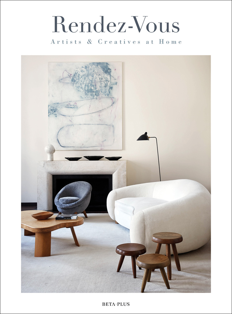 White curved sofa, with three wood stools, cream fire surround, on cover of 'Rendez-Vous Artists & Creatives at Home', by Beta-Plus.