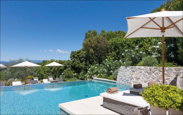 Book cover of Mediterranean Living: By Francobelge Interiors, with a Mediterranean villa with swimming pool. Published by Beta-Plus.