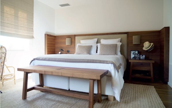 Linen book cover of Les Amandiers Home, Timeless Interiors, with interior living room with tan leather chairs, fireplace, and low wood coffee-table. Published by Beta-Plus.