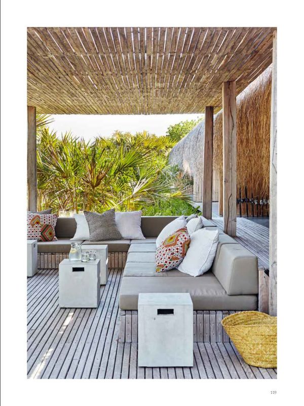 Modern building with flat roof surrounded by long green grass, on white cover of 'Paradise Found, Exceptional Homes in Extraordinary Places', by Beta-Plus.