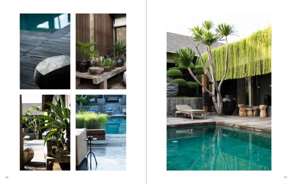 Swimming pool in landscaped garden through interior glass doors, table and chairs on patio, on cover of 'Ultimate Gardens & Swimming Pools', by Beta-Plus.