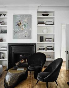 Interior dining space with wood table and chairs, high ceiling, low light fitting, UNDERSTATED ELEGANCE New Urban Living in white font above.
