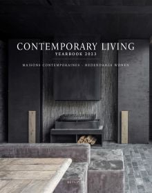 Dark grey interior with slate tiles, modern steel fireplace with logs, 'CONTEMPORARY LIVING YEARBOOK 2023', in white font above.