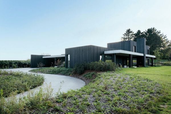 Book cover of Contemporary Living Yearbook 2023, with a dark grey interior of slate tiles, and a modern steel fireplace with logs. Published by Beta-Plus.