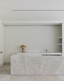 Interior bathroom with natural stone walls, sink below with wood surround, on cover of 'Nec Plus Ultra', by Beta-Plus.