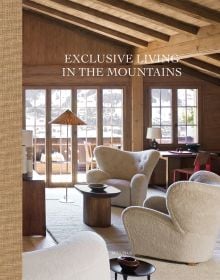 Book cover of Exclusive Living in the Mountains, with interior of wood chalet with cream sofa, and view over mountains. Published by Beta-Plus.