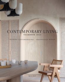 Interior with cream textured walls, with arched double doors, wooden chair and table, on cover of 'Contemporary Living Yearbook 2024', by Beta-Plus.