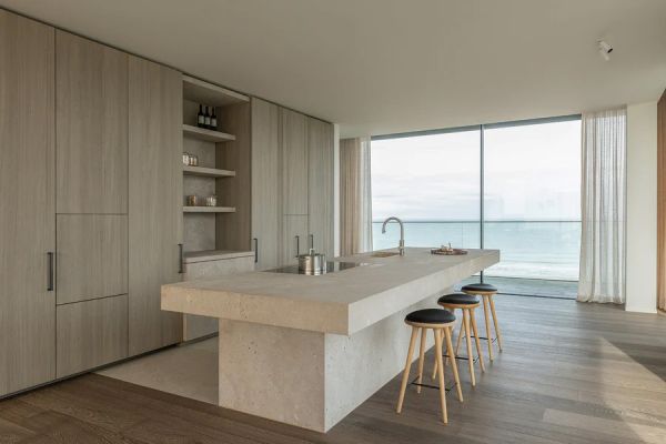 Green linen book cover of World's Finest Apartments, with interior dining space with dark wood veneered walls, long table with green, velvet covered chairs. Published by Beta-Plus.