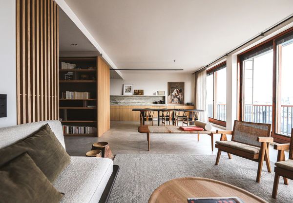 Green linen book cover of World's Finest Apartments, with interior dining space with dark wood veneered walls, long table with green, velvet covered chairs. Published by Beta-Plus.