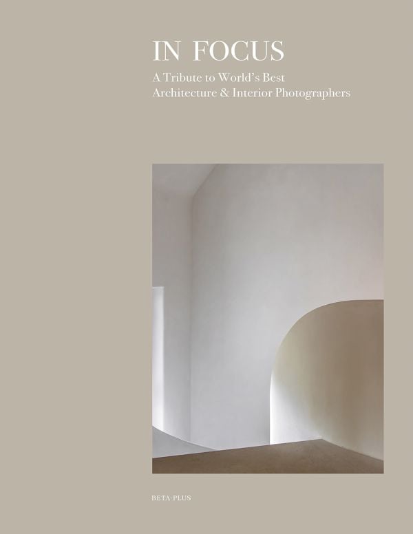 Book cover of In Focus: A Tribute to World's Best Architecture & Interior Photographers, with a pale interior wall arch. Published by Beta-Plus.
