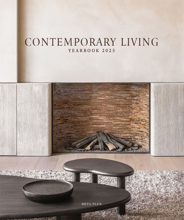Book cover of Contemporary Living Yearbook 2025, with an interior living room with brick fireplace, pale walls and dark wood furniture. Published by Beta-Plus.