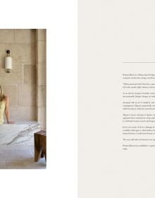 Book cover of The Feminine Touch: 33 Interior Designers Defining Tomorrow, with an interior with a marble sink and floral walls. Published by Beta-Plus.