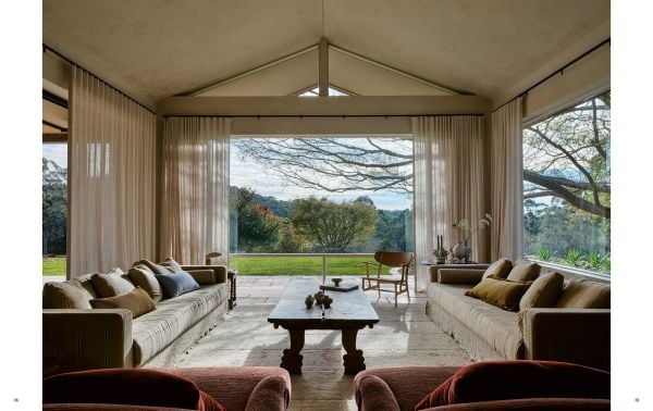 Book cover of The Feminine Touch: 33 Interior Designers Defining Tomorrow, with an interior with a marble sink and floral walls. Published by Beta-Plus.