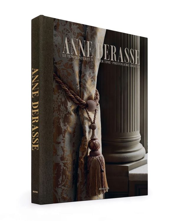 Book cover of Anne Derasse: Inner Time, with an interior room with curtain with tassel tie and stone column behind. Published by Beta-Plus.