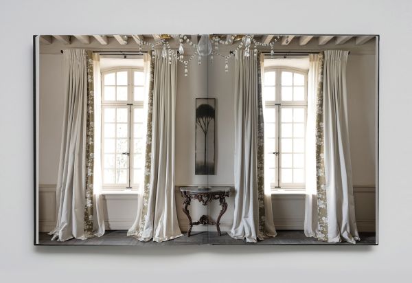 Book cover of Anne Derasse: Inner Time, with an interior room with curtain with tassel tie and stone column behind. Published by Beta-Plus.