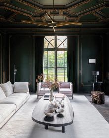 Book cover of Timeless Residences, with a pale interior hallway with stone tiled floor and two dark wood chairs with white upholstery. Published by Beta-Plus.