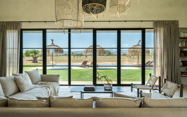 Book cover of Summer Residences, with interior living space with cream carpet, wood furniture, with double doors opening out to landscape. Published by Beta-Plus.