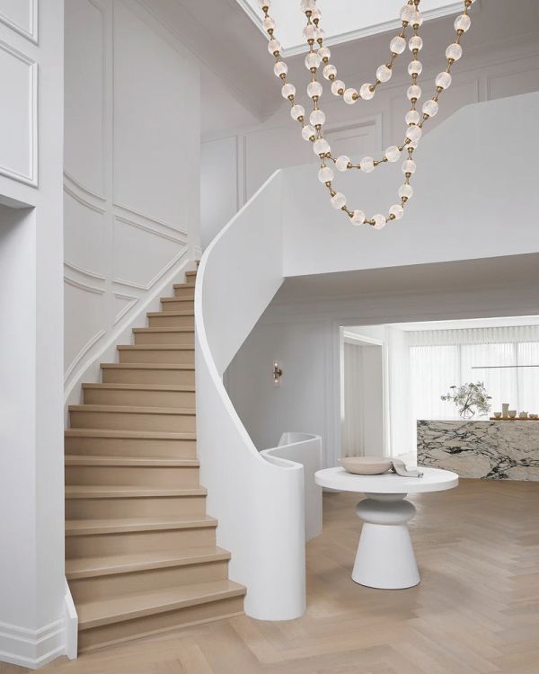 Book cover of World's Best II: 50 Interiors From Around the Globe, featuring a minimalist interior with marble table and long white drapes. Published by Beta-Plus.