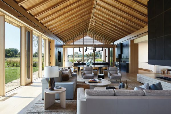 Book cover of World's Best II: 50 Interiors From Around the Globe, featuring a minimalist interior with marble table and long white drapes. Published by Beta-Plus.