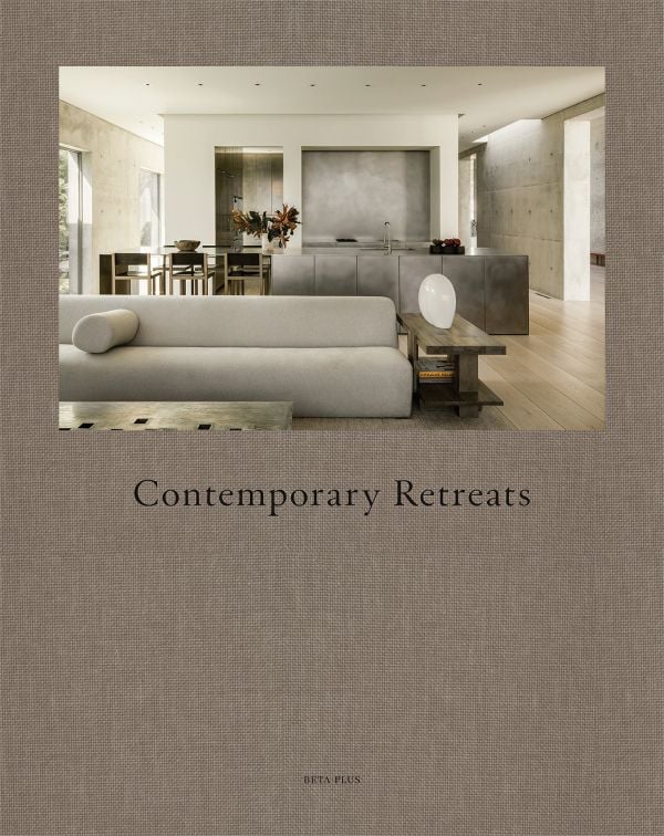 Linen book cover of Contemporary Retreats, featuring an interior living space in shades of gray. Published by Beta-Plus.