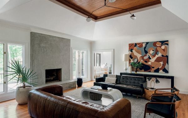 Book cover of Young Visionaries: A New Generation of Interior Designers: featuring an interior living room with modern sculptures on dark wood table. Published by Beta-Plus.