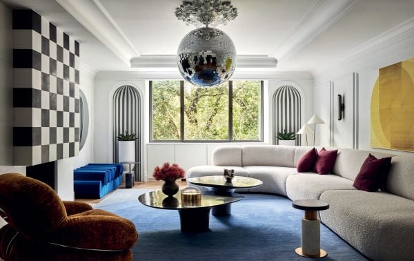 Book cover of Young Visionaries: A New Generation of Interior Designers: featuring an interior living room with modern sculptures on dark wood table. Published by Beta-Plus.