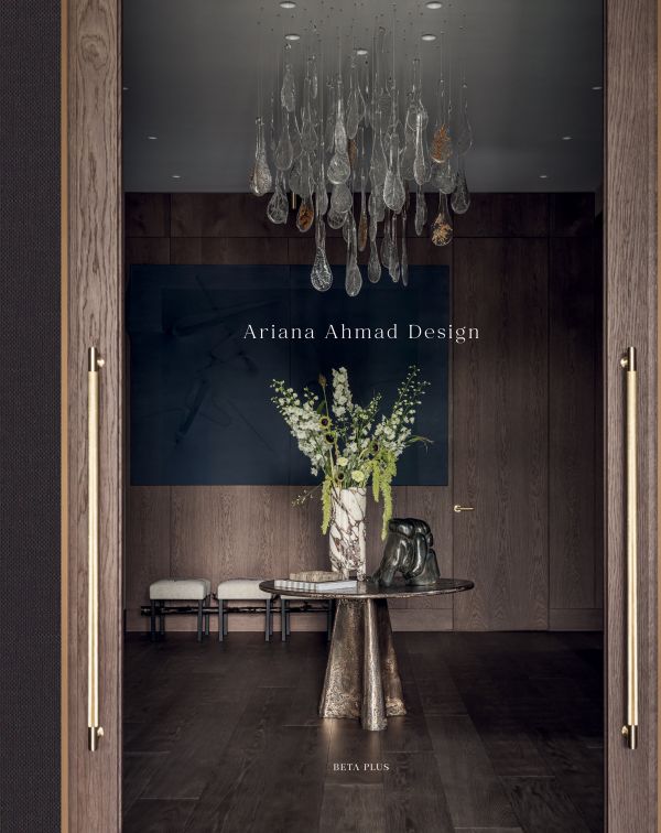Book cover of Ariana Ahmad Design; featuring a dark interior living space with wood panelling and a modern chandelier. Published by Beta-Plus.
