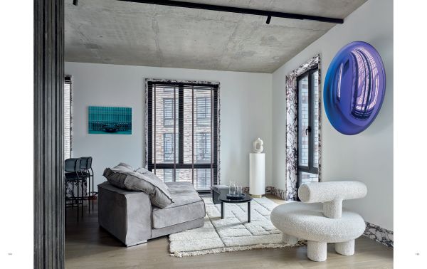 Book cover of Ariana Ahmad Design; featuring a dark interior living space with wood panelling and a modern chandelier. Published by Beta-Plus.