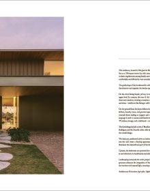 Book cover of Quatre Mains: Creative Duos In Architecture & Interior Design; featuring an interior room with dark green panelled walls and a large brown armchair. Published by Beta-Plus.