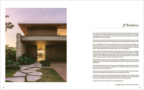Book cover of Quatre Mains: Creative Duos In Architecture & Interior Design; featuring an interior room with dark green panelled walls and a large brown armchair. Published by Beta-Plus.