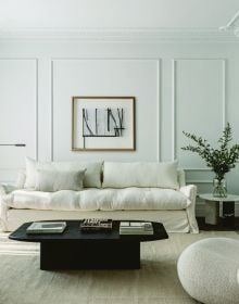 Book cover of Quatre Mains: Creative Duos In Architecture & Interior Design; featuring an interior room with dark green panelled walls and a large brown armchair. Published by Beta-Plus.