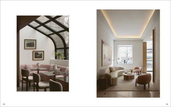 Book cover of Quatre Mains: Creative Duos In Architecture & Interior Design; featuring an interior room with dark green panelled walls and a large brown armchair. Published by Beta-Plus.