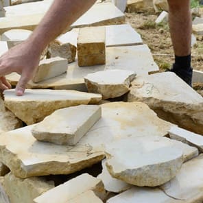 Technical drawing on brick facade in brown and beige, Crafting the Facade in stencilled font above