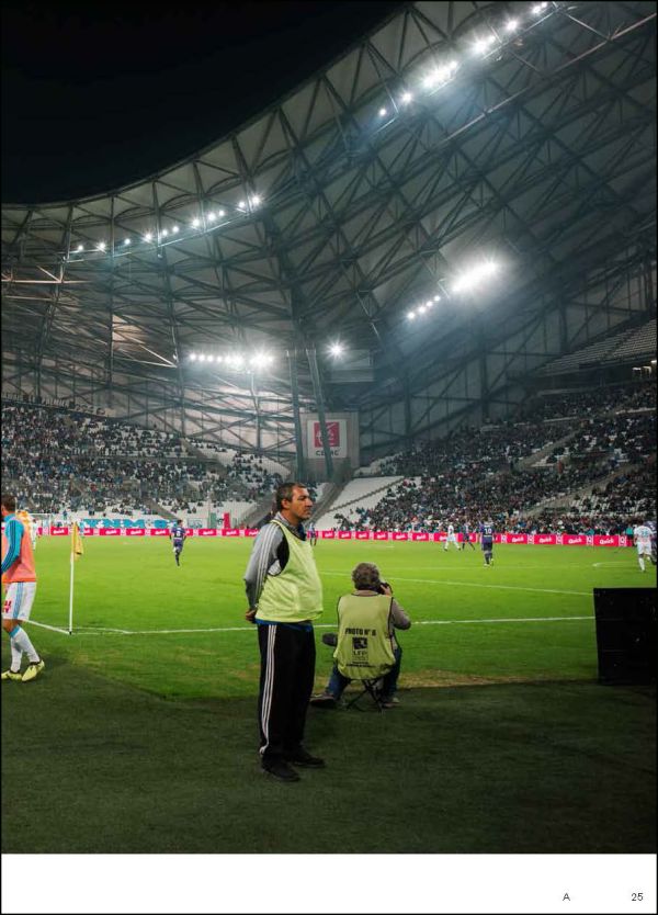 Man on white plinth taking photo of landscape, on white cover, Creatures of the City in black font above