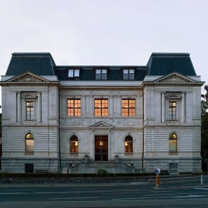 DARWIN'S THEATRE in white arched font on black cover, Tower of Babel by Bruegel the Elder to top.