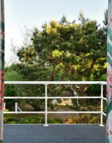 White flat roof villa surrounded by green trees, JOSEF FRANK: VILLA CARLSTEN in white font below