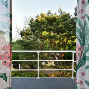 White flat roof villa surrounded by green trees, JOSEF FRANK: VILLA CARLSTEN in white font below