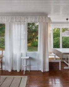 White flat roof villa surrounded by green trees, JOSEF FRANK: VILLA CARLSTEN in white font below
