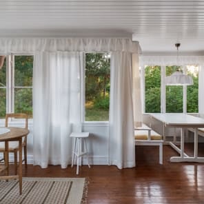 White flat roof villa surrounded by green trees, JOSEF FRANK: VILLA CARLSTEN in white font below