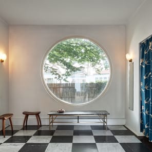 White flat roof villa surrounded by green trees, JOSEF FRANK: VILLA CARLSTEN in white font below