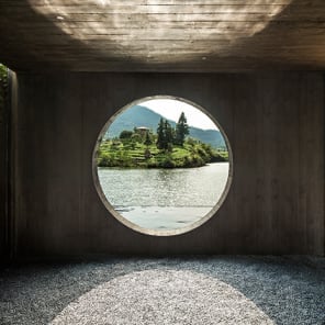 Row of wood buildings, steps leading up towards hilly landscape, The Songyang Story in black font above.