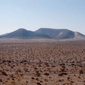 Green and grey filtered image, Huellas in grey font to top, Josep Lluís Mateo Escritos 2005–2020 in black font below.