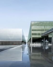 Landscape shot of exterior of Toulouse Parc des expositions et Centre de convention, on grey cover, OMA – Toulouse Exhibition and Convention Center in black and grey font below.