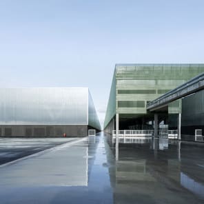 Landscape shot of exterior of Toulouse Parc des expositions et Centre de convention, on grey cover, OMA – Toulouse Exhibition and Convention Center in black and grey font below.