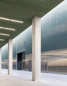 Landscape shot of exterior of Toulouse Parc des expositions et Centre de convention, on grey cover, OMA – Toulouse Exhibition and Convention Center in black and grey font below.